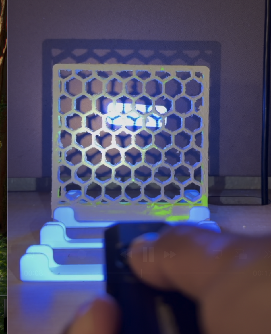 UV torch shining through honeycomb — blue glow visible